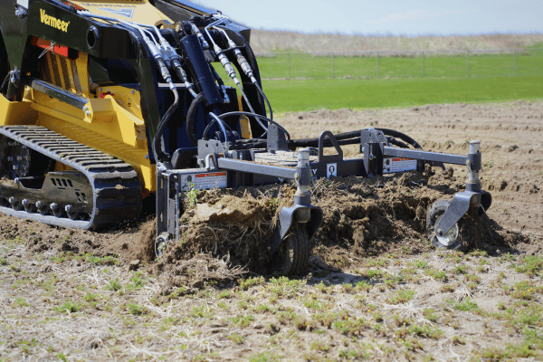 Vermeer Mini Skid Steer with Harley Rake attachment
