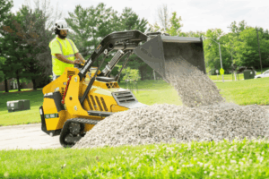 Vermeer ML100 Mini Loader with bucket dumping gravel